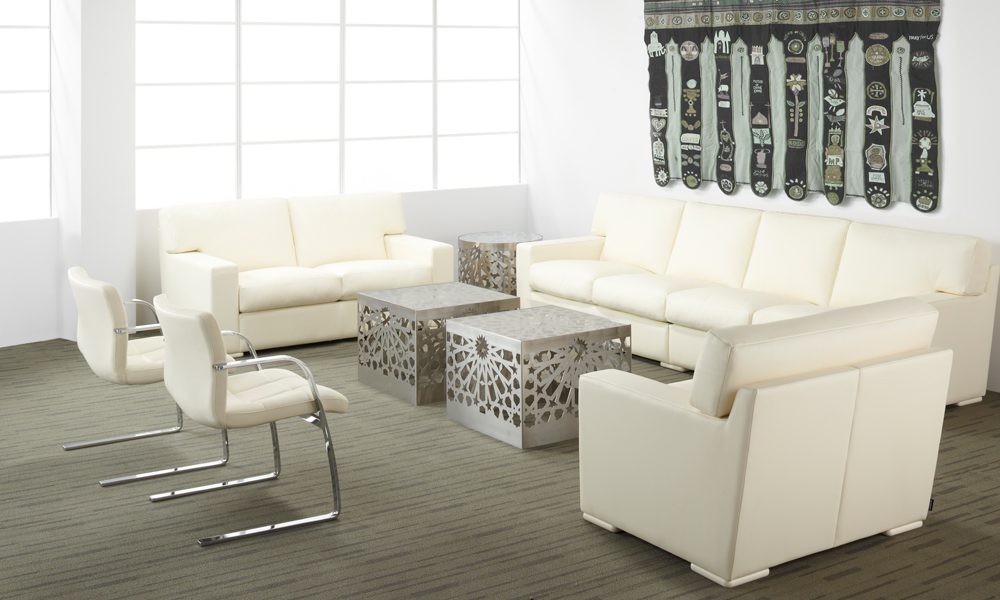 The leather upholstered Baden and Zurich couch and chairs by Nienkamper in white.