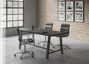 An office desk with three chairs
