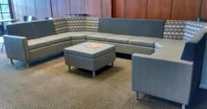 Gray colored seating provided in the lobby of the office